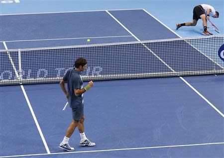 Switzerland's Roger Federer (L) reacts during his semi-final match against Vasek Pospisil (R) of Canada at the Swiss Indoors ATP tennis tournament in Basel October 26, 2013. REUTERS/Arnd Wiegmann