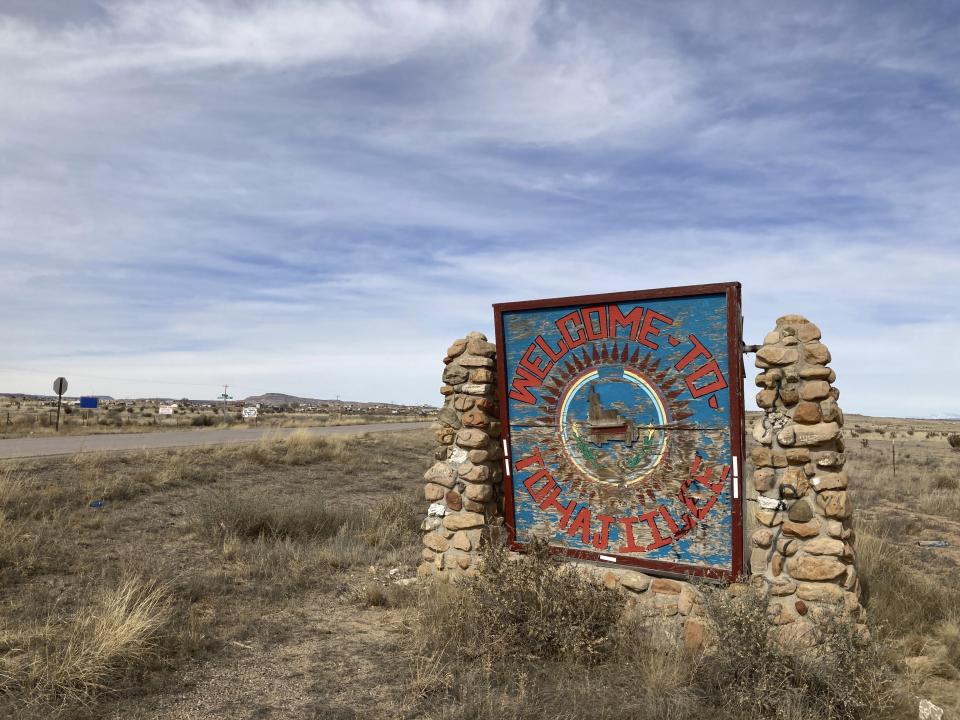 This Feb. 17, 2023 image shows a sign along the road heading into the Navajo community of To'Hajiilee, New Mexico. To'Hajiilee Community School is just one of dozens funded by the U.S. Bureau of Indian Education that are in desperate need of repair or replacement. The agency estimates it would cost roughly $6.2 billion to address the needs of those schools in poor condition. (AP Photo/Susan Montoya Bryan)