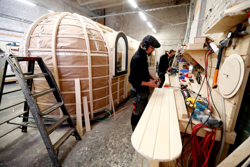 Iglucraft company workers work on Iglusaun sauna details in Leie