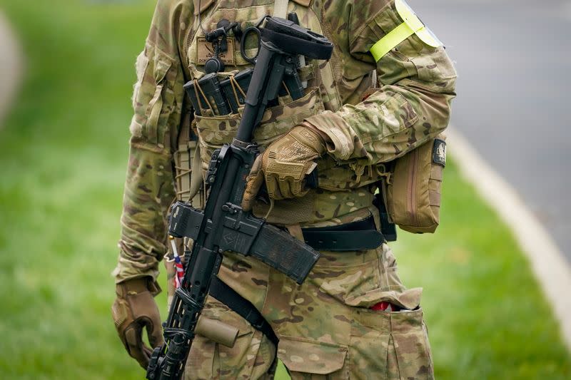 FILE PHOTO: A member with the Three Percenters militia provides security for a "Patriot Day 2nd Amendment Rally" in support of gun rights at the State Capitol in Frankfort