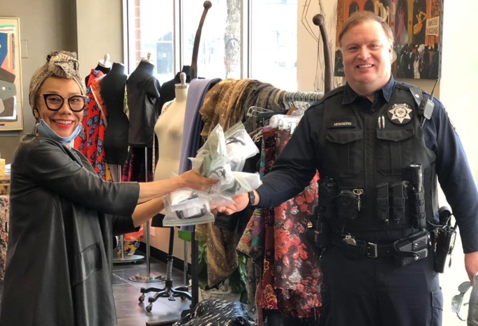 Barbara Bates hands masks to a police officer at her studio in Chicago. (Courtesy of Barbara Bates)