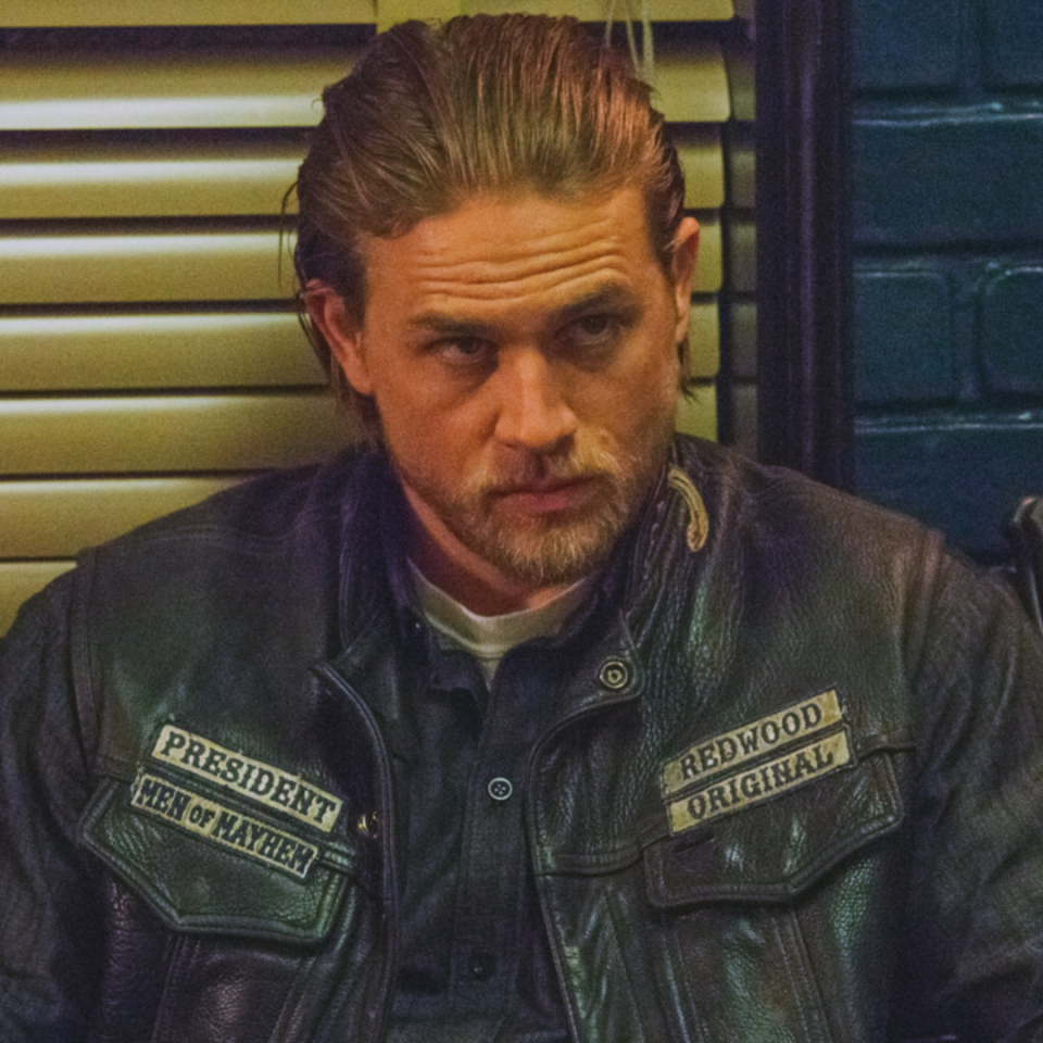 Charlie Hunnam as Jax Teller in "Sons of Anarchy," wearing a black leather vest with patches