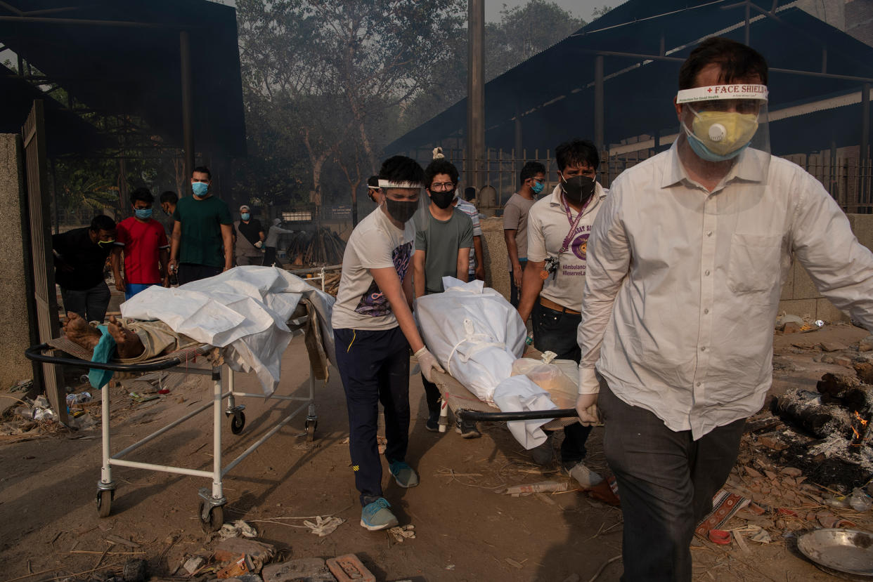 Relatives carry the body of a loved one at a crematorium in New Delhi on April 27, as India endures the world's worst COVID-19 outbreak.