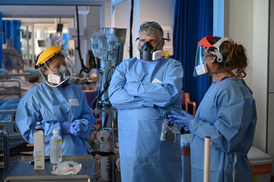 Members of the clinical staff wear personal protective equipment (PPE) as they care for patients at the Intensive Care unit at Royal Papworth Hospital in Cambridge, England. Photo: Neil Hall/AFP/Getty