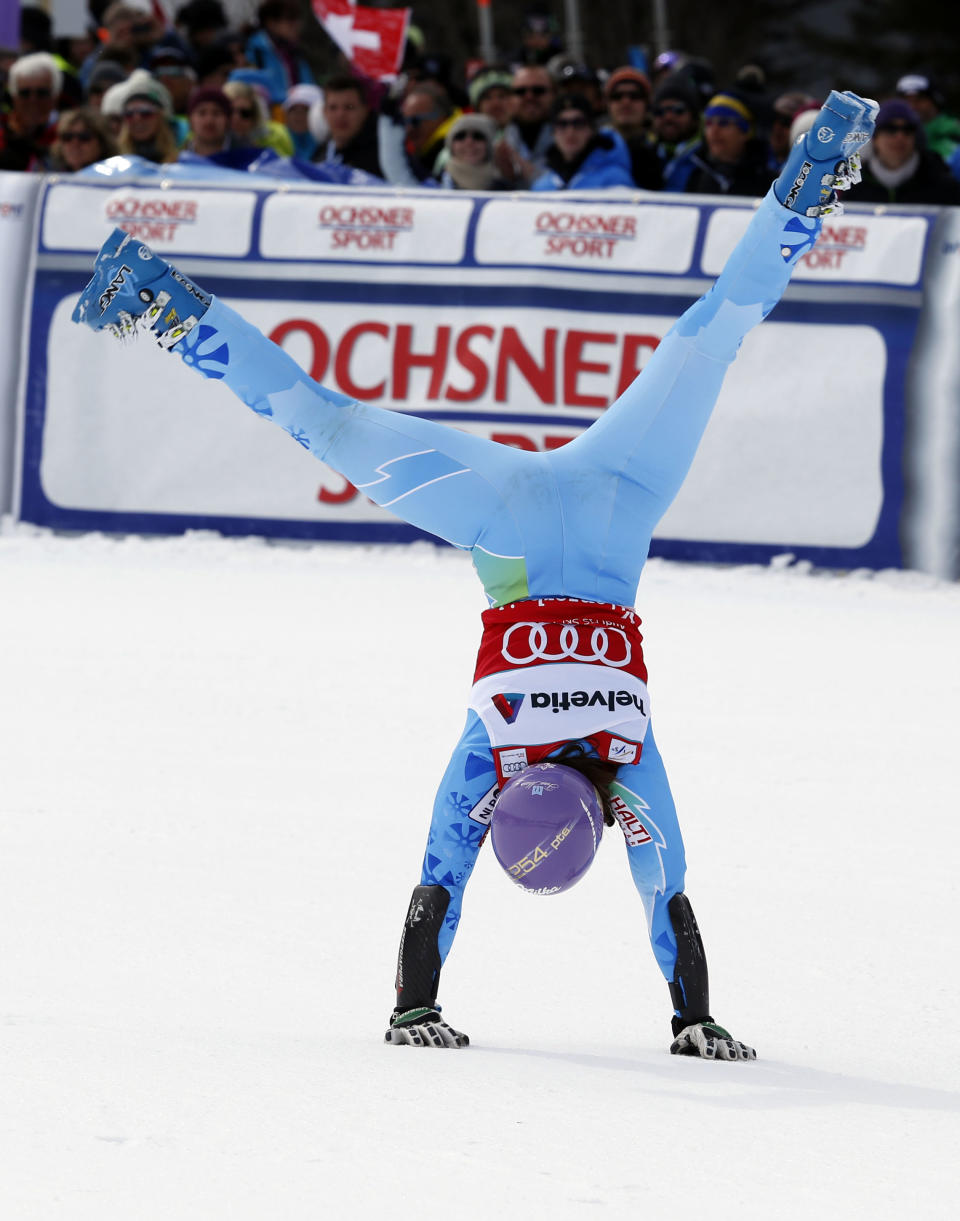 FILE - In this Sunday, March. 17, 2013, file photo, Slovenia's Tina Maze cartwheels after winning the women's alpine skiing giant slalom at the World Cup finals in Lenzerheide, Switzerland. The biggest puzzle in Alpine skiing approaching the Sochi Olympics was working out what happened to Tina Maze. After her historically good 2012-13 season, 11 World Cup wins, record points total, one world championships gold medal , the 30-year-old Slovenian fit perfectly as a potential Winter Games star. Maze celebrated victories with her exuberant trademark, a cartwheeling handspring across the snow. This season, she was clearly unhappy as her winless streak stretched into January, unwilling or unable to explain what she described in her blog as "mediocre results." All that changed last Saturday, Jan. 25, 2014, when Maze raced to an elusive first win in a downhill at Cortina d'Ampezzo, Italy. (AP Photo/Alessandro Trovati, File)