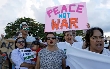 Local residents chants slogans during a peace rally at Chief Quipuha Park, on the island of Guam, a U.S. Pacific Territory, August 14, 2017. REUTERS/Erik De Castro