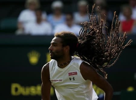 Dustin Brown of Germany serves during his match against Rafael Nadal of Spain at the Wimbledon Tennis Championships in London, July 2, 2015. REUTERS/Stefan Wermuth