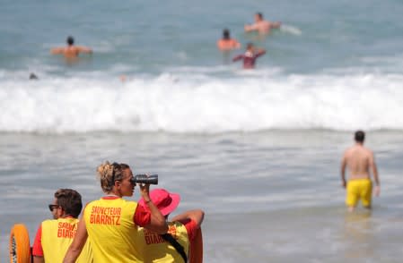 Lifeguards watch swimmers at the beach ahead of the G7 summit in Biarritz