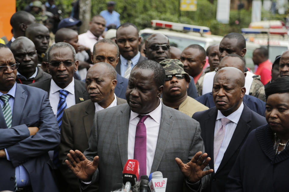 Kenya's Interior Minister Fred Matiang'i as he gives a statement at the scene of yesterday's extremist gunmen attack, Wednesday, Jan. 16, 2019, in Nairobi, Kenya. Extremists stormed a luxury hotel in Kenya's capital on Tuesday, setting off thunderous explosions and gunning down people at cafe tables in an attack claimed by Africa's deadliest Islamic militant group (AP Photo/Khalil Senosi)