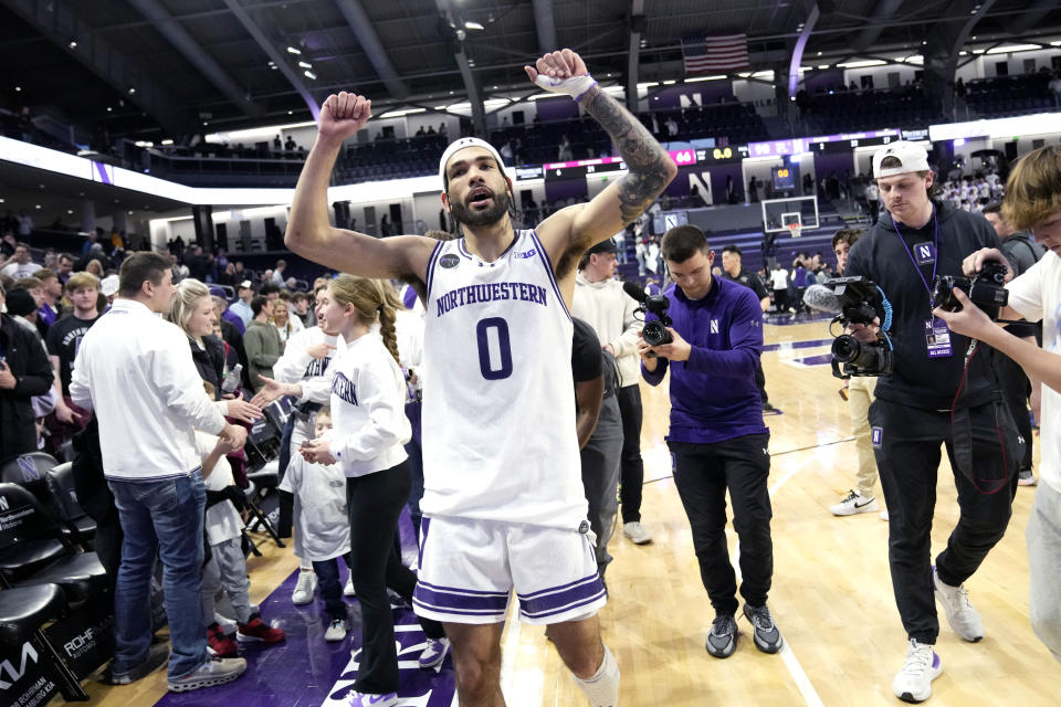 Northwestern guard Boo Buie (0) celebrates as he walks off the court after an NCAA college basketball game against Minnesota in Evanston, Ill., Saturday, March 9, 2024. (AP Photo/Nam Y. Huh)