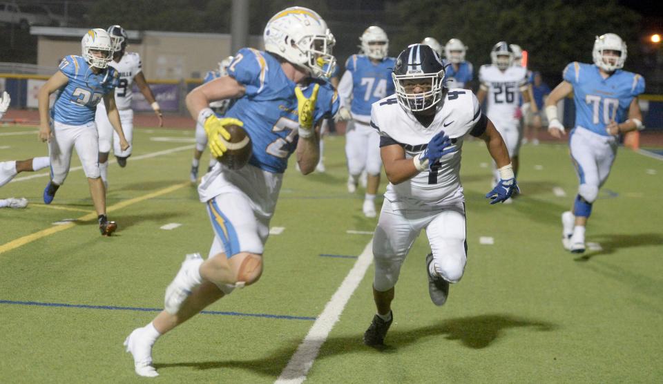 Agoura receiver Miles Hull tries to get past Camarillo middle linebacker Jackson Walea during the teams' Canyon League opener at Agoura High on Thursday, Sept. 14, 2023. Agoura won 34-27 to improve to 5-0 on the season.