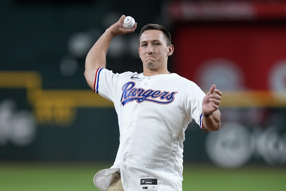 Texas Rangers first-round draft pick Wyatt Langford throws out a ceremonial first pitch before the Rangers' baseball game against the Tampa Bay Rays, Tuesday, July 18, 2023, in Arlington, Texas. (AP Photo/Tony Gutierrez)