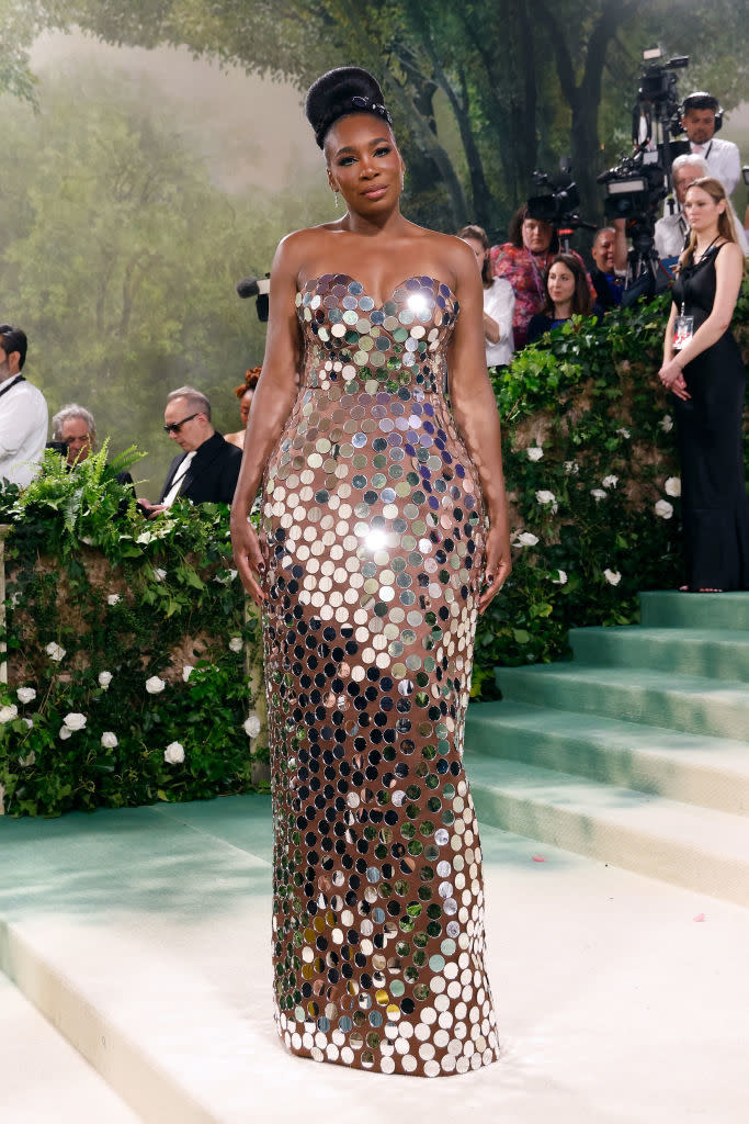 Serena Williams in a fitted gown with mirror-like embellishments on a Met Gala red carpet