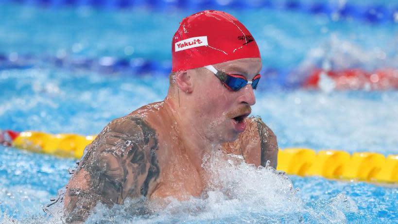 Adam Peaty swimming breaststroke in a race