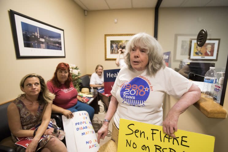 Amina Kruck protests in the lobby of U.S. Sen Jeff Flake's office in Phoenix on July 5, 2017. (Photo: Loren Townsley/Arizona Republic)