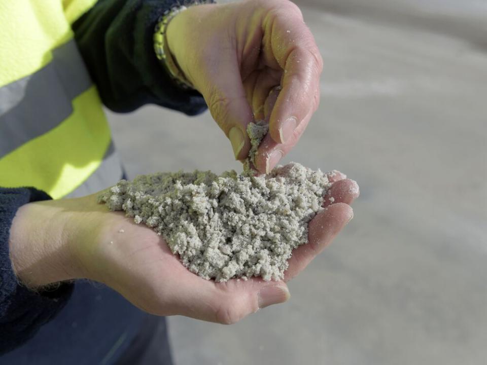  An employee holds processed lithium at a facility in Australia.