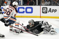 Edmonton Oilers right wing Kailer Yamamoto, left, attempts to score on Los Angeles Kings goaltender Jonathan Quick before colliding with him during the first period in Game 6 of an NHL hockey Stanley Cup first-round playoff series Thursday, May 12, 2022, in Los Angeles. Yamamoto received a penalty on the play. (AP Photo/Mark J. Terrill)