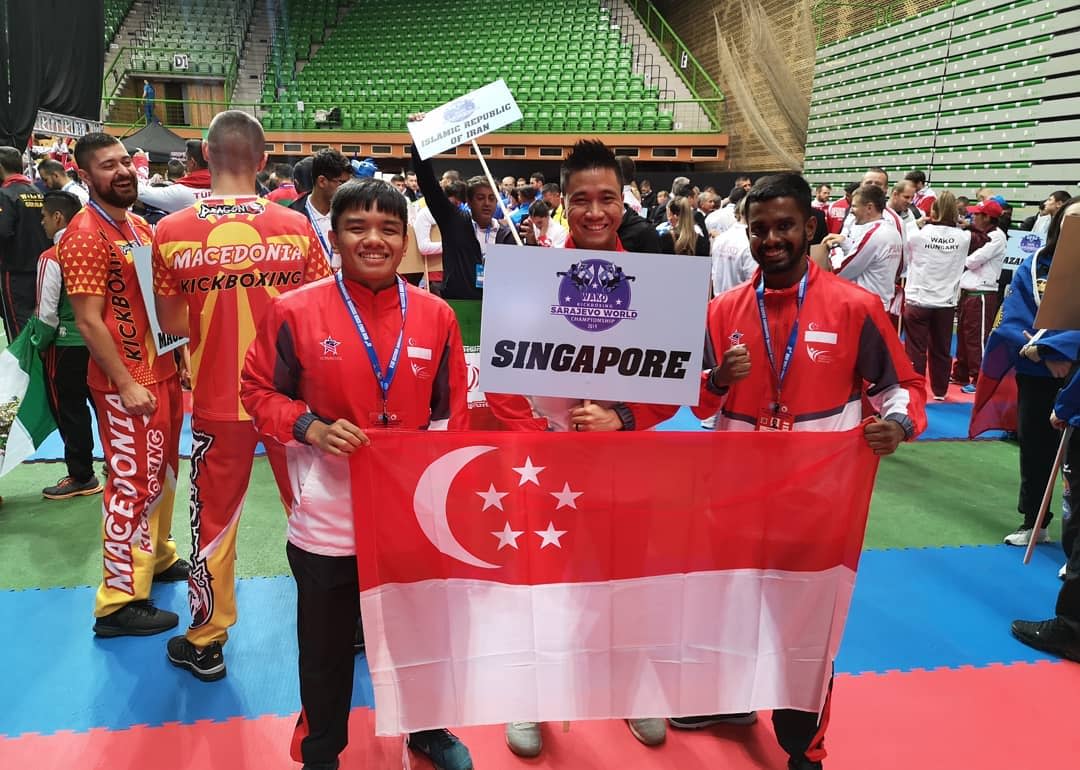 Singapore athletes Nazri Sutari (left) and Abdul Rahman (right) at the World Kickboxing Championships with Joel Lye, vice-president of the Kickboxing Federation of Singapore. (PHOTO: Kickboxing Federation of Singapore)