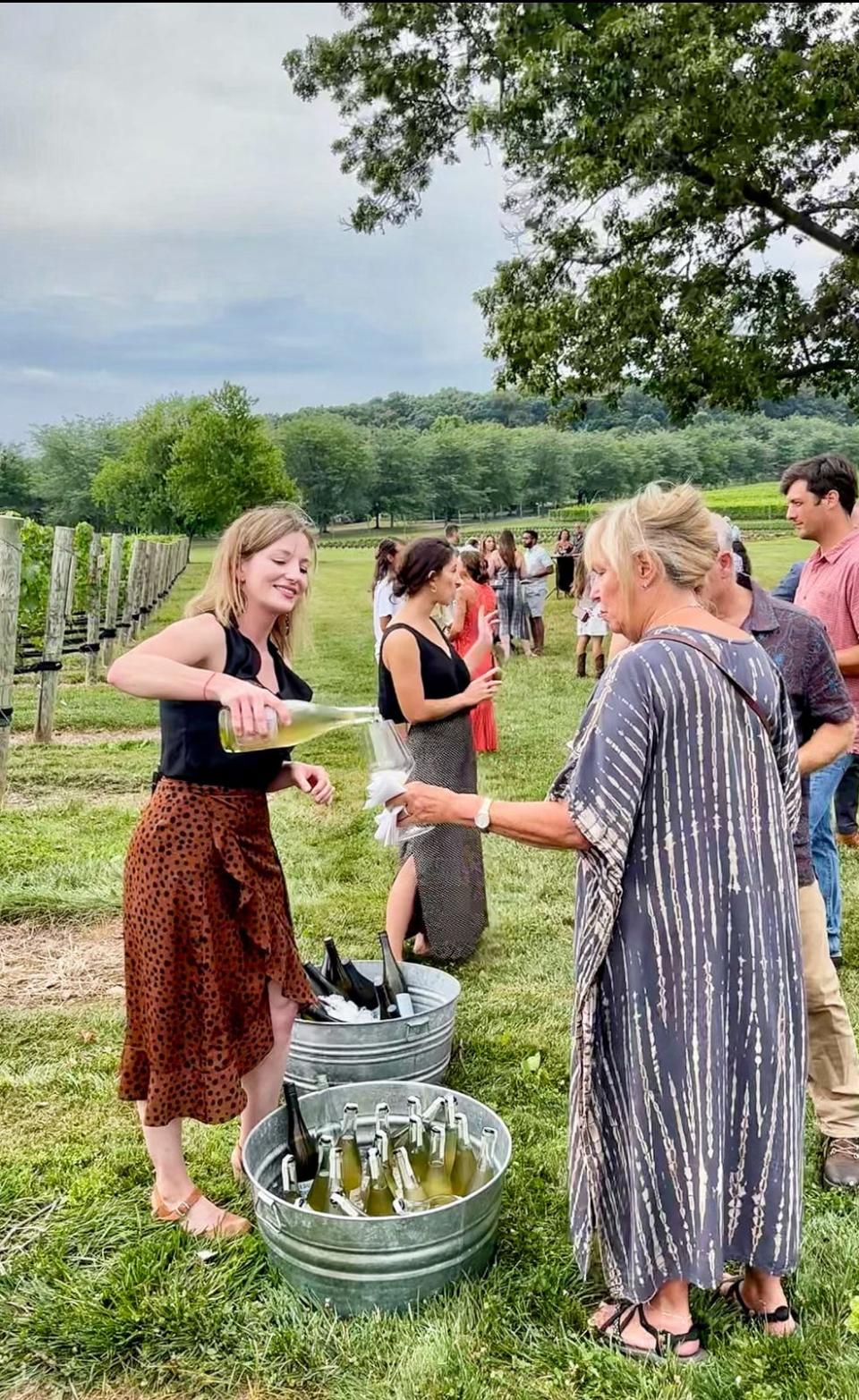 Amy Rose, tasting room manager at Beneduce Winery, pours wine for guests celebrating the Hunterdon County winery's 10th anniversary.