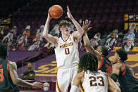 Minnesota's Liam Robbins (0) shoots as Maryland's Galin Smith (30) defends in the first half of an NCAA college basketball game, Saturday, Jan. 23, 2021, in Minneapolis. (AP Photo/Jim Mone)