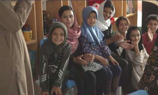 PHOTO: A teacher gives lessons to Zarlasht and other children in Salam Cafe.  (ABC News)