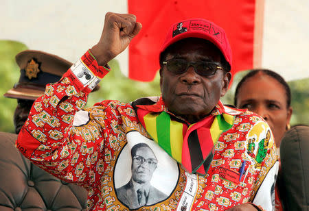 FILE PHOTO - Zimbabwe's President Robert Mugabe gestures at an election rally in the small town of Shamva, Zimbabwe May 29, 2008. REUTERS/Philimon Bulawayo/File Photo