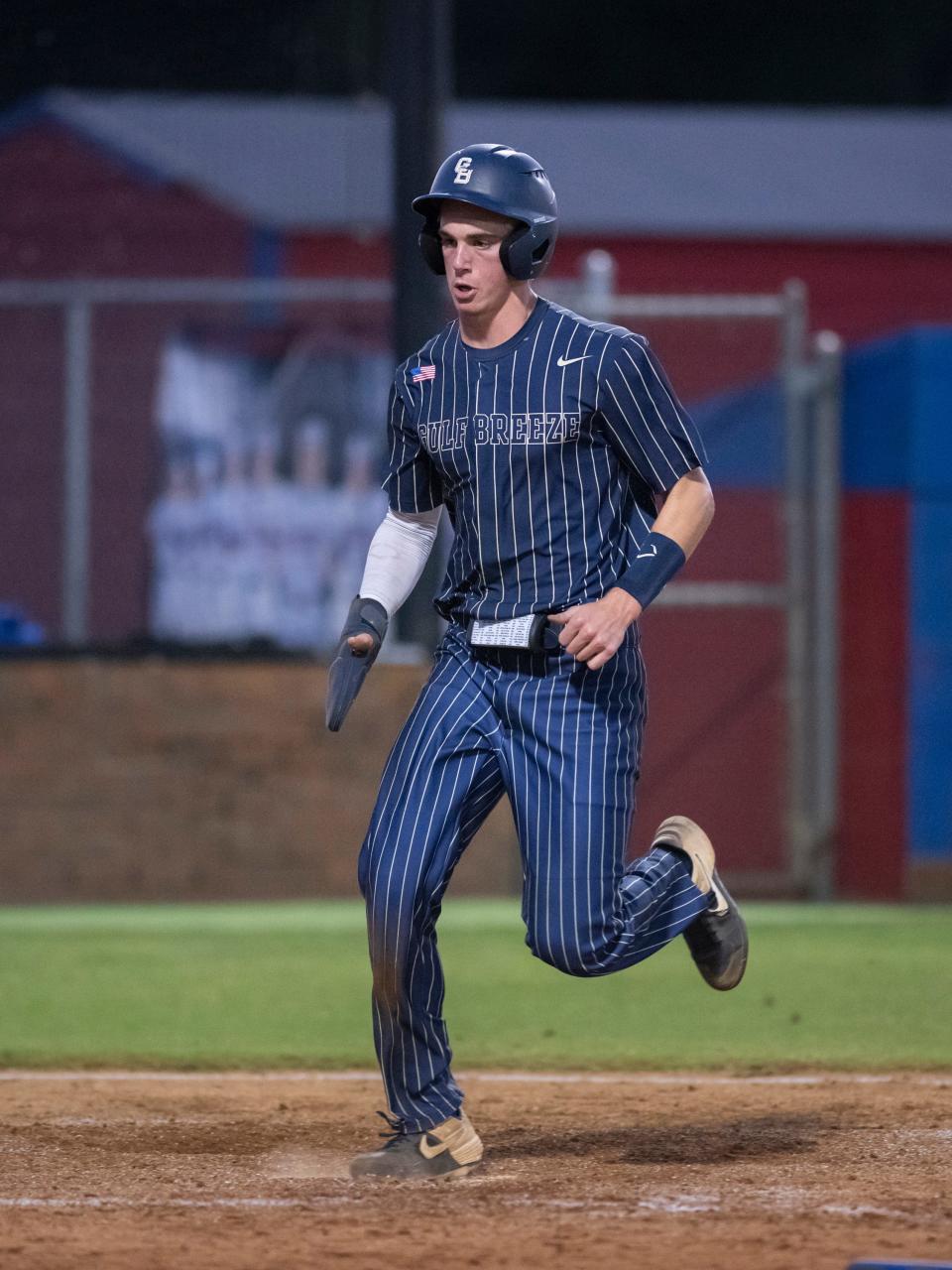 Brock Clayton (1) crosses the plate to score as the Dolphins expand their lead to 3-1 in the top of the 3rd inning during the Gulf Breeze vs Pine Forest 5A regional quarterfinal baseball game at Pine Forest High School in Pensacola on Tuesday, May 10, 2022.