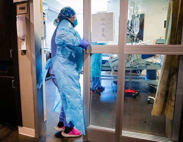 PHOTO: A nurse enters a room Tuesday in the COVID ICU to administer treatment to a patient at SSM Health St. Anthony Hospital.<p>CP choice 2 (Chris Landsberger/The Oklahoman via USA Today Networks)