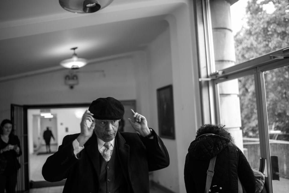 <p>Spencer Leak Sr adjusts his hat, as he exits his fifth funeral of the day at South Park Bapitst Church on Chicago’s south side. (Photo: Jon Lowenstein/NOOR for Yahoo News) </p>