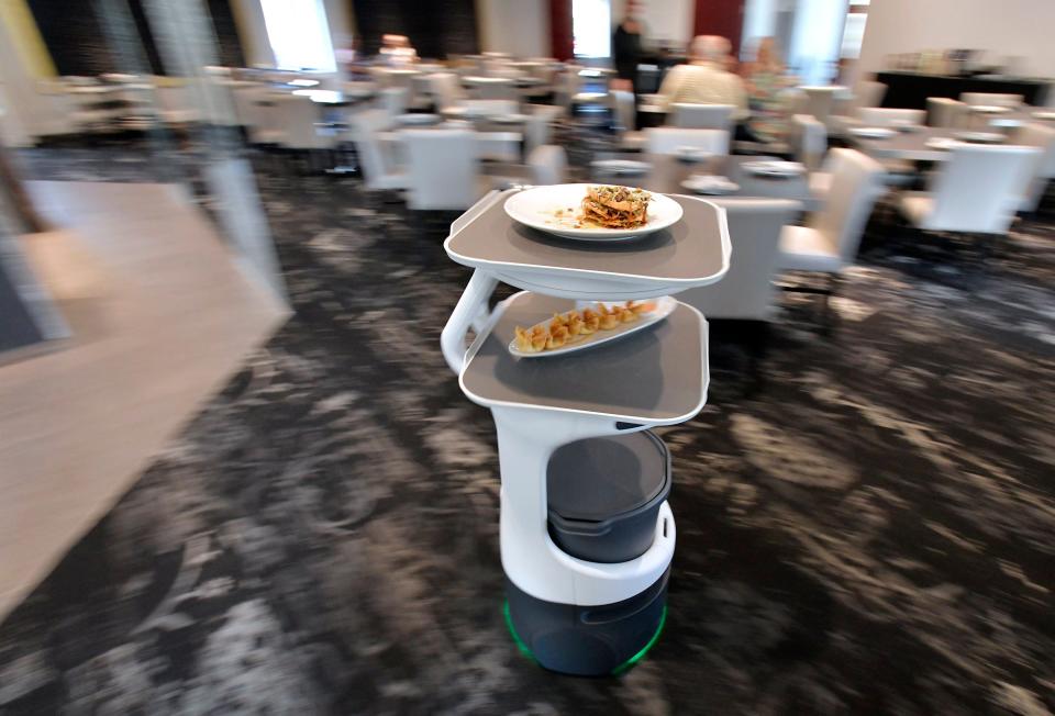 Booey the robot shuttles a customer's food order from the kitchen through the dining room to the customer's table at Blue Bamboo Canton Bistro in Jacksonville. Chef  and owner Dennis Chan is among the first, if not the first, Jacksonville restauranteur, to have the state-of-the-art robot on staff.