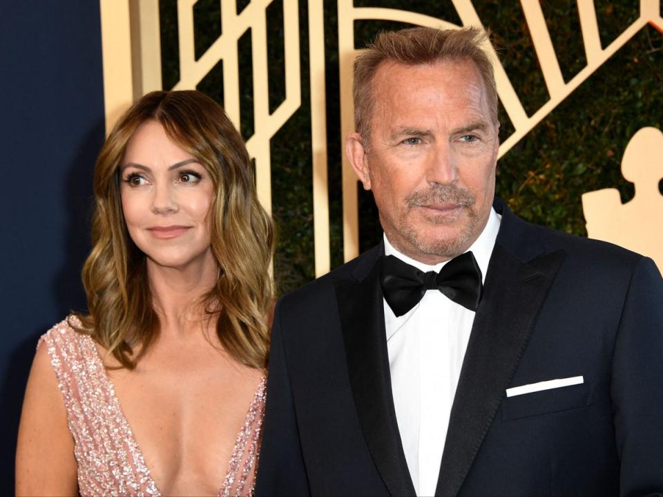 Kevin Costner and Christine Baumgartner photographed in 2022 (AFP via Getty Images)