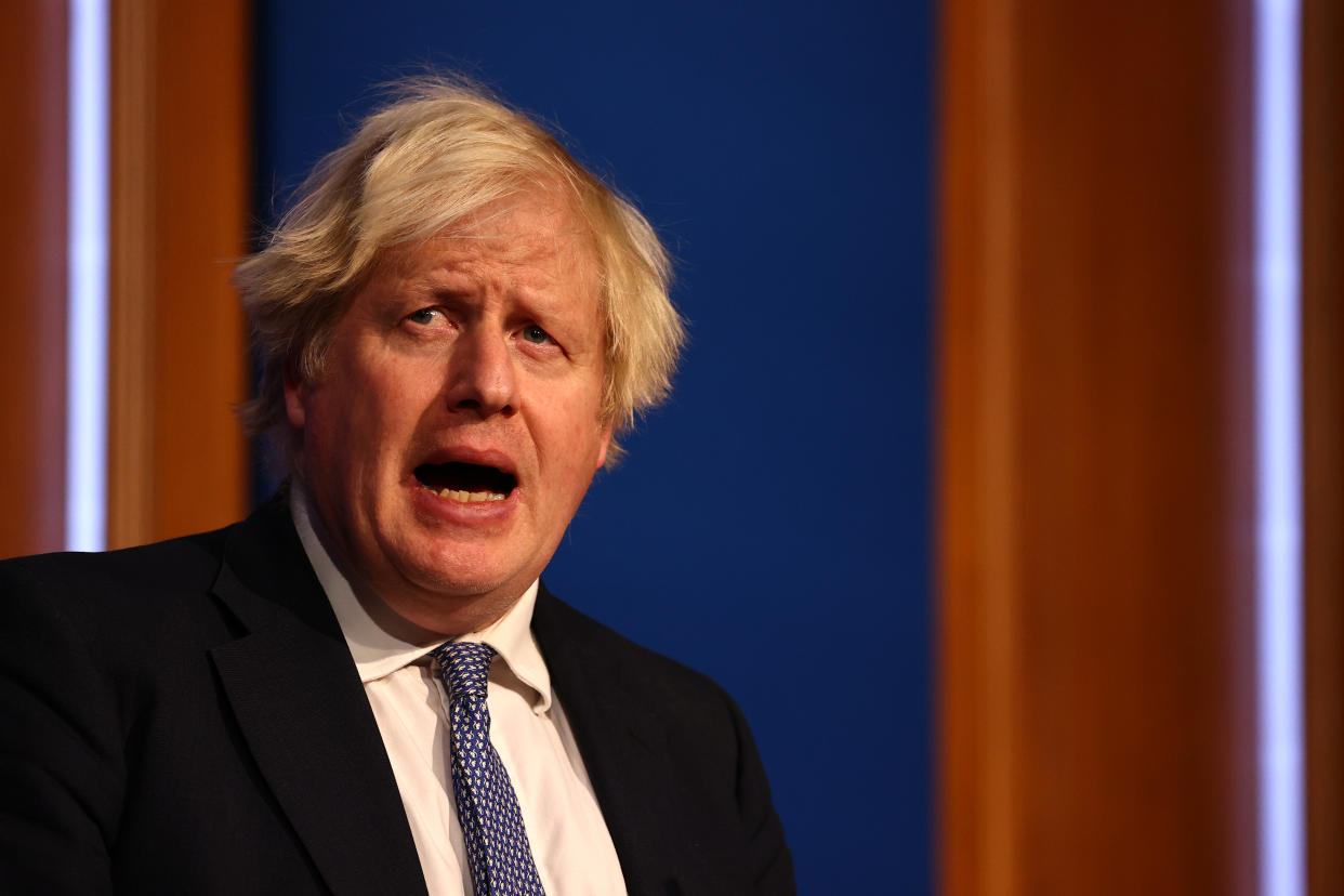 LONDON, ENGLAND - DECEMBER 08: British prime Minister Boris Johnson gives a press conference at 10 Downing Street on December 8, 2021 in London, England. During the press conference, the Prime Minister announced that the government will implement its “Plan B” due to the rapid transmission of the Omicron variant. The work from home guidance has been reintroduced, mask wearing at public indoor venues will be enforced and mandatory COVID-19 vaccination passports will be required for entrance into crowded venues such as nightclubs. (Photo by Adrian Dennis-WPA Pool/Getty Images)