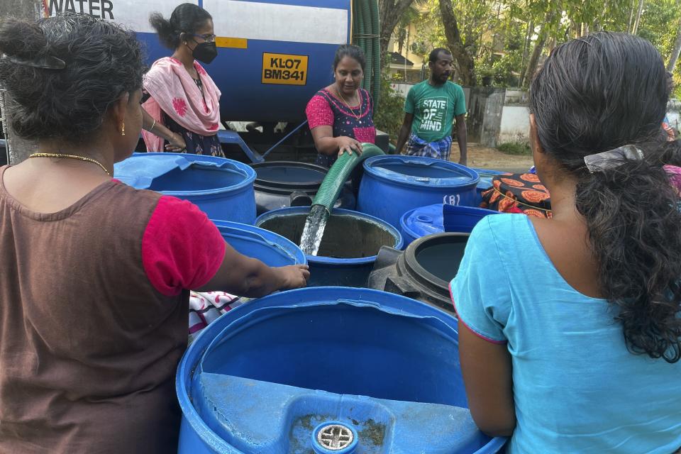 Women wait for their turn to collect water in barrels from a tanker in the Chellanam area of Kochi, Kerala state, India, March 1, 2023. Saltwater's intrusion into freshwater is a growing problem linked to climate change and in Chellanam rising salinity means residents can no longer depend on ponds and wells for the water they need to drink, cook and wash. (Uzmi Athar/Press Trust of India via AP)