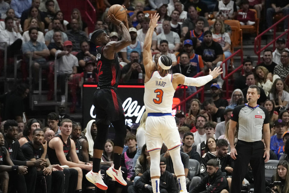 Miami Heat forward Jimmy Butler (22) attempts a 3-pointer as New York Knicks guard Josh Hart (3) defends during the first half of an NBA basketball game, Tuesday, April 2, 2024, in Miami. (AP Photo/Lynne Sladky)
