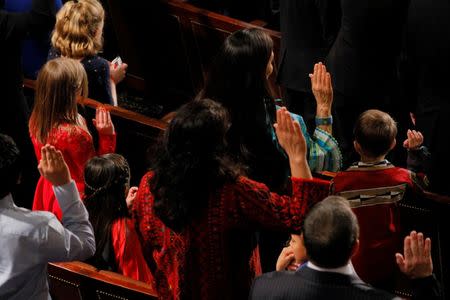 Deb Haaland (top R), wearing traditional Native American attire, takes the oath of office to become one of the first two first Native American women in the U.S. House of Representatives in Washington, U.S., January 3, 2019. REUTERS/Brian Snyder