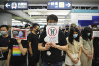 Demonstrators stand in silence during a protest at the Yuen Long MTR station in Hong Kong, Wednesday, Aug. 21, 2019. Japan's top diplomat on Tuesday told his Chinese counterpart that Japan is "deeply concerned" about the continuing protests in Hong Kong. (AP Photo/Kin Cheung)