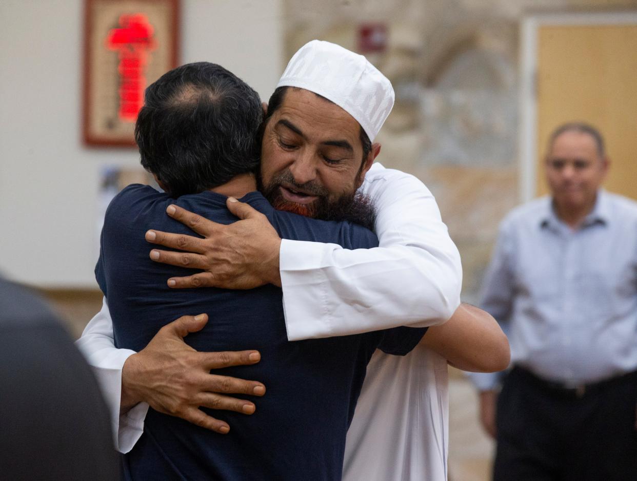 Muslims embrace after Friday prayer services at the Islamic Center of New Mexico during Friday prayer services on August 12, 2022. Muhammand Azfaal Hussain, whom was murdered, attended this mosque in Albuquerque, New Mexico. 