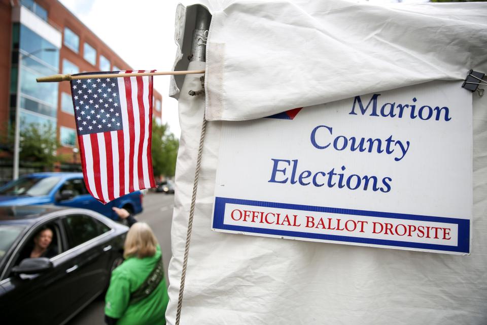 Voters drop off their ballots on election day at a drive-thru location outside the Marion County Courthouse.