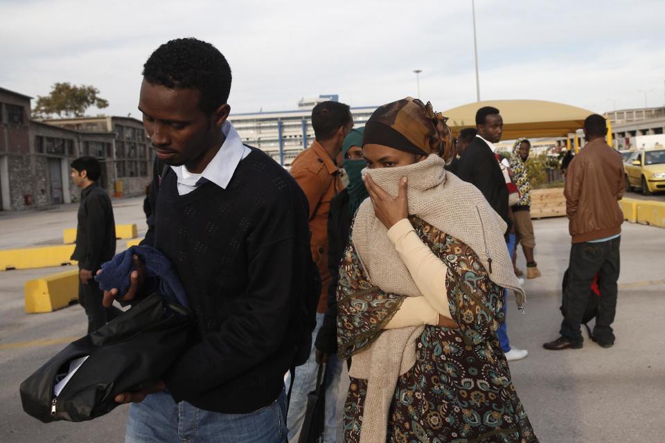 African immigrants, two of among 32 who survived from one of the deadliest migrant boat accidents which occurred on May 5 in Greek waters, arrives at the port of Piraeus, near Athens, on Monday, May 12, 2014. At least 22 people, including families trapped in a flooded cabin, drowned when a yacht and a dinghy crammed with migrants trying to slip into Greece capsized last week in the eastern Aegean Sea, next to the island of Samos, authorities said. (AP Photo/Petros Giannakouris)