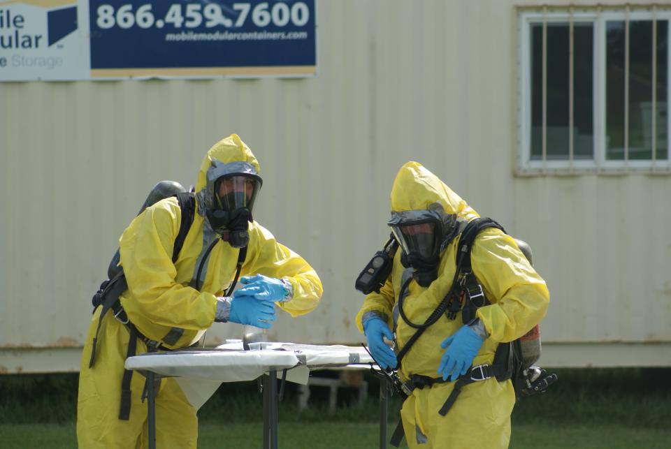 Two firefighters "burp" a bottle that was used to cook meth during a training program Friday, Aug. 19, 2022, in Golden Meadow. The two are being taught the process to ensure that after the raid of a lab, the substances don't explode from the chemical reactions.