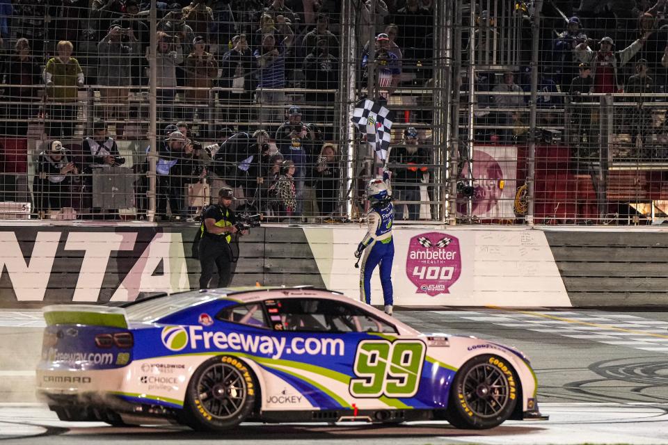 Daniel Suarez (99) celebrates after winning the Ambetter Health 400 at Atlanta Motor Speedway.