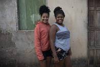 Sara Pompeu da Silva, left, and Ludmika Pompeu pose for a photo amid the new coronavirus pandemic at the Maria Joaquina "Quilombo" in Cabo Frio, on the outskirts of Rio de Janeiro, Brazil, Sunday, July 12, 2020. More than 100 families in the community are trying to endure the coronavirus outbreak. (AP Photo/Silvia Izquierdo)