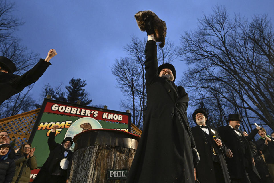 Groundhog Club handler A.J. Dereume holds Punxsutawney Phil, the weather prognosticating groundhog, during the 138th celebration of Groundhog Day on Gobbler's Knob in Punxsutawney, Pa., Friday, Feb. 2, 2024. Phil's handlers said that the groundhog has forecast an early spring. (AP Photo/Barry Reeger)