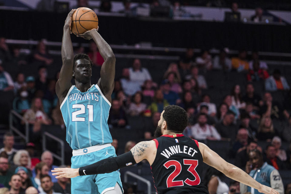 Charlotte Hornets forward JT Thor (21) shoots while guarded by Toronto Raptors guard Fred VanVleet (23) during the first half of an NBA basketball game in Charlotte, N.C., Tuesday, April 4, 2023. (AP Photo/Jacob Kupferman)