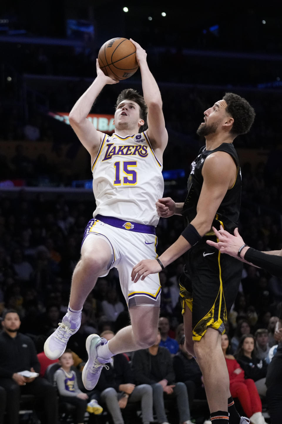 Los Angeles Lakers' Austin Reaves (15) puts up a shot as Golden State Warriors' Klay Thompson watches during the first half of an NBA basketball game, Sunday, March 5, 2023, in Los Angeles. (AP Photo/Jae C. Hong)