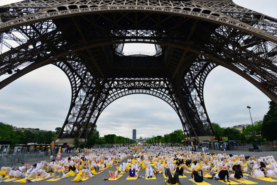 Hundreds of people attend a yoga session on the square at the foot of the Eiffel Tower on June 21, 2015 in Paris, France. 192 countries join in for a mass yoga session to mark the first International Yoga Day. (Frederic Stevens/Getty Images)