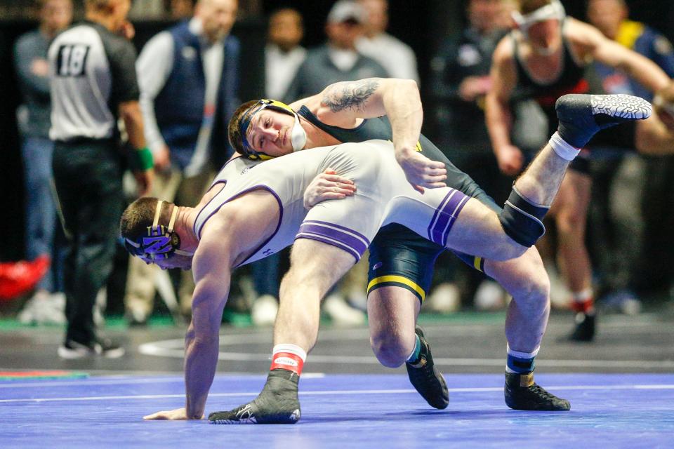 Michigan's Mason Parris takes down Northwestern's Lucas Davison during day two of the NCAA Wrestling Championships 2023 at the BOK Center in Tulsa, Okla. on Friday, March 17, 2023.