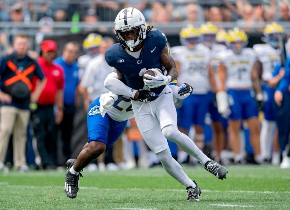 A Delaware defender reaches for Penn State wide receiver KeAndre Lambert-Smith during the game on Saturday, Sept. 9, 2023.