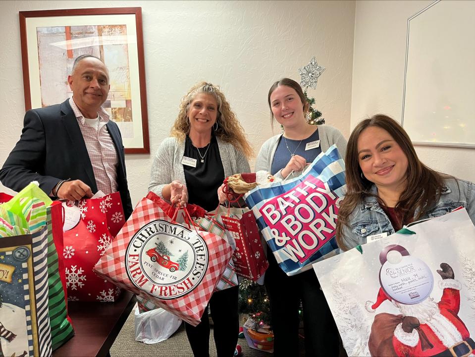 The Home Instead team has already started collecting gifts for "Be a Santa to a Senior." Left to right: Sandeep Bhatia, owner of Home Instead, Kathleen Hulsey, home care consultant, Sarah Joaquin, scheduling coordinator and Kimberly Stoffel, office administrator.