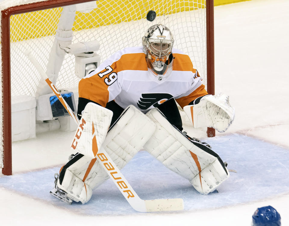 Philadelphia Flyers goaltender Carter Hart (79) watches the puck during first-period NHL Eastern Conference Stanley Cup first round playoff hockey game action against the Montreal Canadiens in Toronto, Friday, Aug. 21, 2020. (Frank Gunn/The Canadian Press via AP)